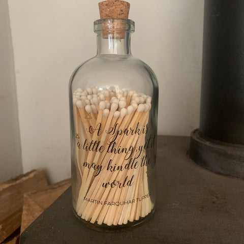 Long white matches in glass bottle - 'A spark is..'